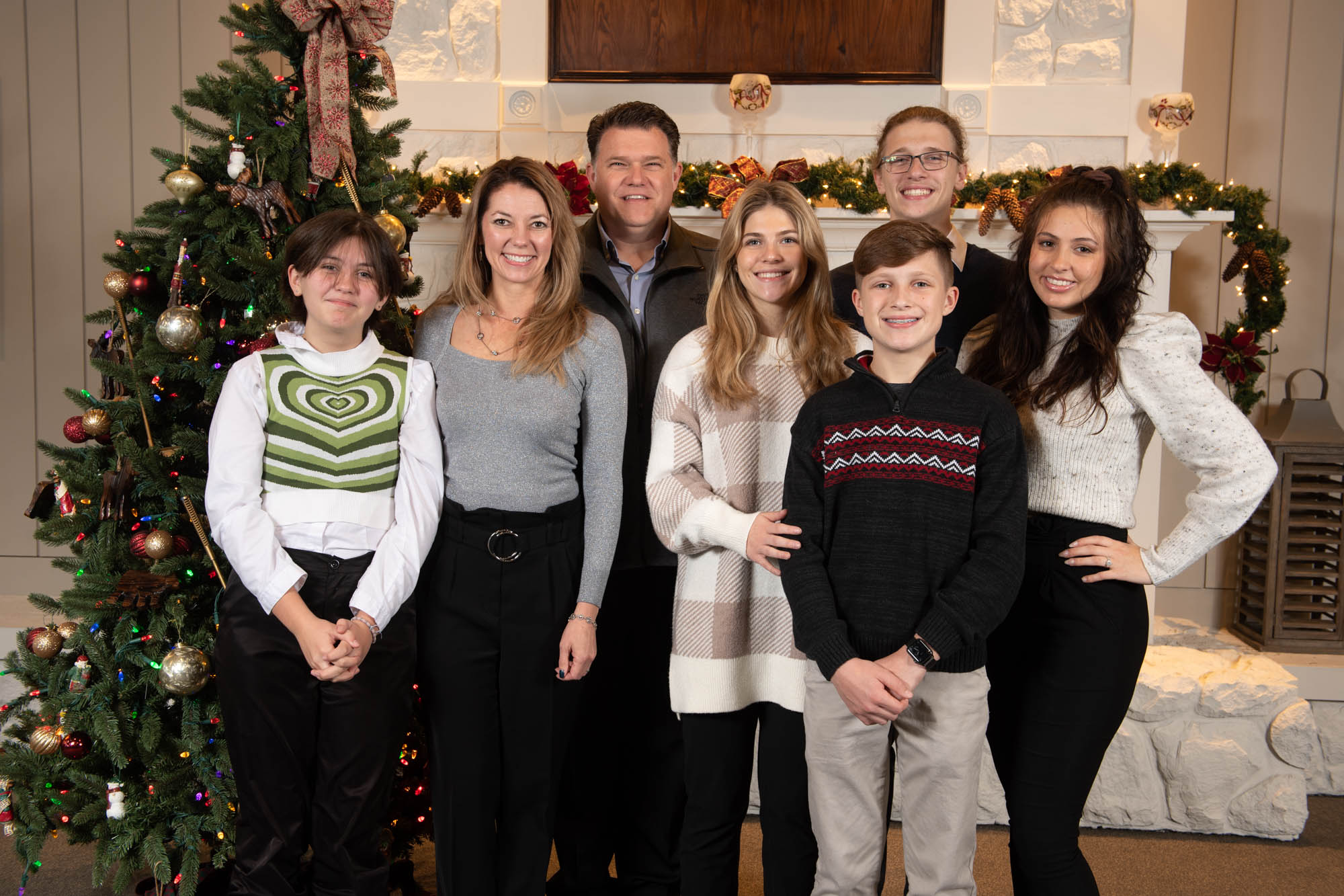 Family gathered by the Christmas Tree